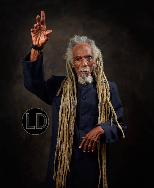 Emrold Phillip is Brother Valentino.  He sang Be Aware, a 50-year-old calypso for 2023. He was hotographed in 2020 for the project.